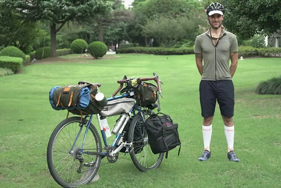 Cyclist Alessandro Gallo with Carradice bags crossing China